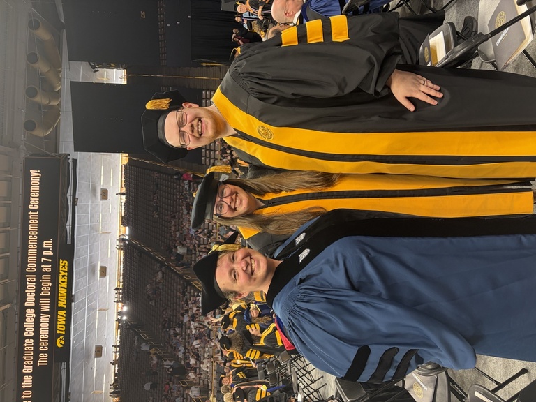 smiling math graduates and professor