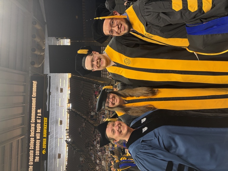 smiling math graduates and professor